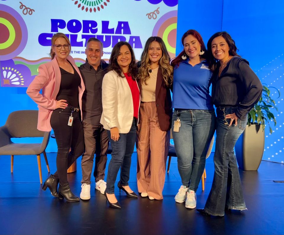 Adelante team members posing together on stage